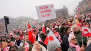 Protesters in Copenhagen holding banners reading Hands off Greenland