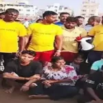 Lifeguards rescuing tourists from strong waves at Swargadwar beach in Puri