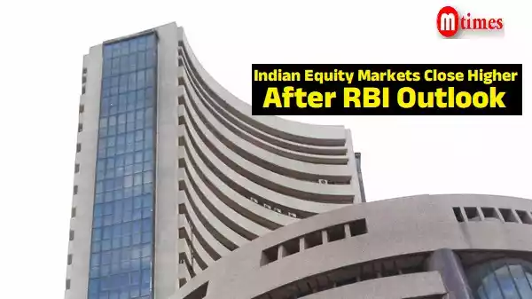 Traders on the NSE floor as Sensex and Nifty close higher