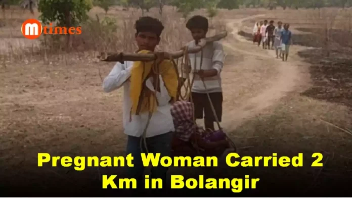 Villagers carrying pregnant woman through rough terrain in Bolangir district