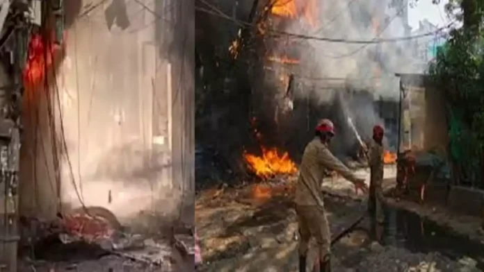 Rescue teams evacuate victims from a fire-ravaged hotel building in Delhi's Malviya Nagar area.